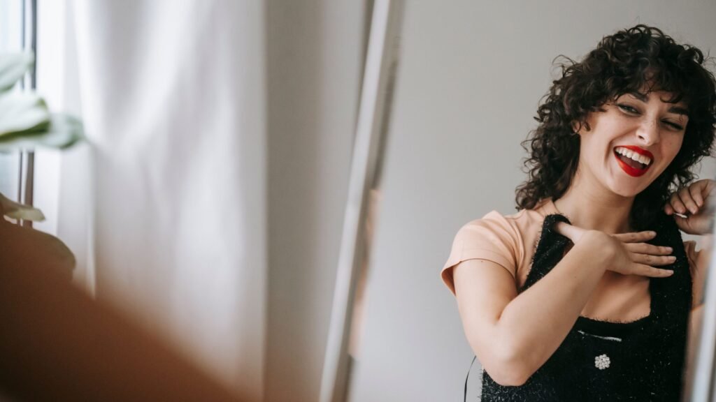 Woman checking outfit proportions and fit in a mirror
