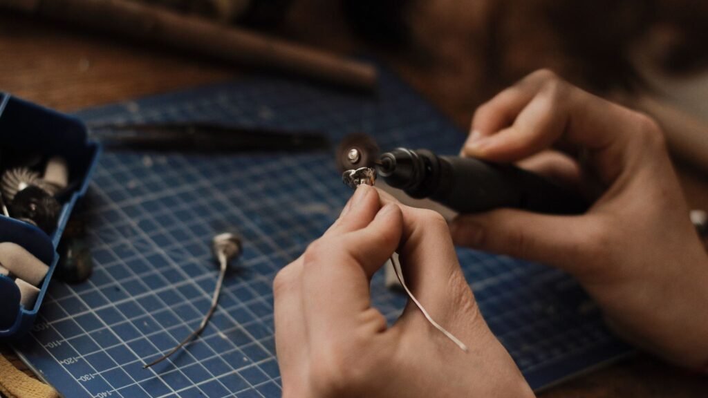 Hands polishing a piece of jewelry as part of routine accessory care