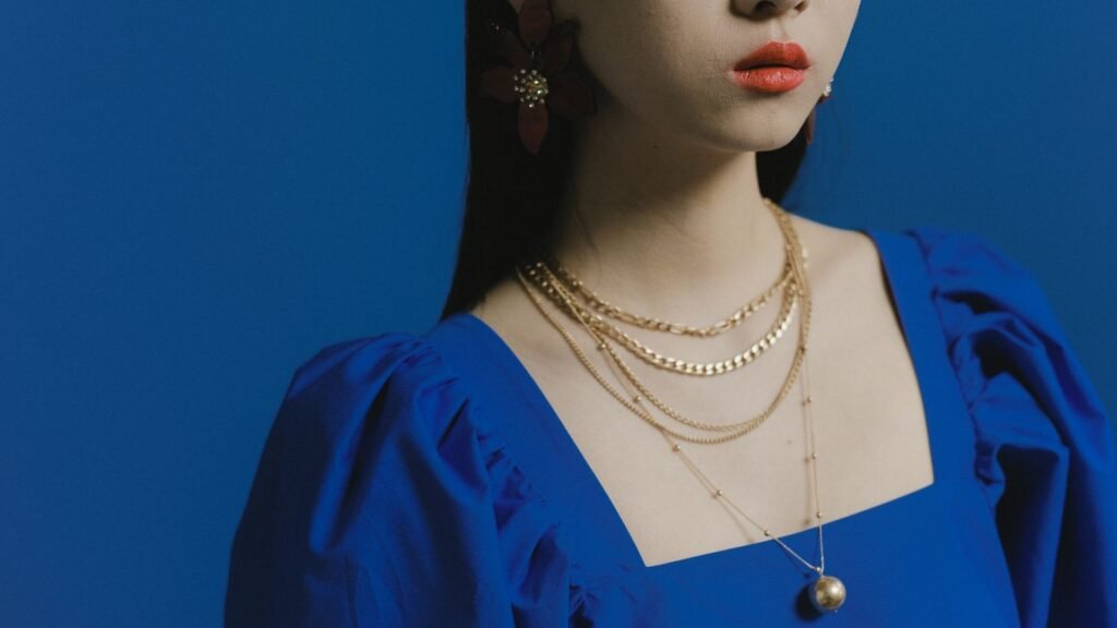 Layered gold necklaces styled together for visual balance